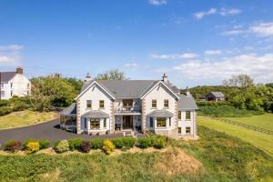 an aerial view of a large white house at Carnbore House BnB in Bushmills