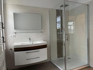 a bathroom with a sink and a shower at Ferienwohnung Helene in Gotha +20 photos