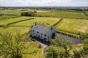 an overhead view of a large white house in a field at Carnbore House BnB in Bushmills