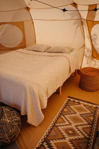a bedroom with a bed in a tent at Glamping Wake Surf Náklo in Olomouc +17 photos
