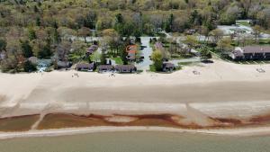 an aerial view of a beach with a resort at Surfside 13 - Cute Lakefront Condo! in Oscoda