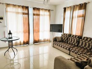 a living room with a couch and a table at Vacation House with Private Pool in Baie du Tombeau