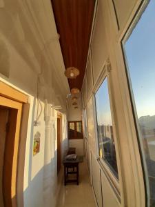 a hallway of a building with a large window at Landour Apartment Beauty and Charm Kothri- Vintage Vibes in Mussoorie