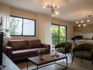 a living room with a couch and a table at Plaza colonial suites by Yellowkey in Santo Domingo