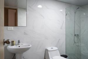 a bathroom with a toilet and a sink and a shower at Plaza colonial suites by Yellowkey in Santo Domingo +56 photos