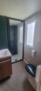 a bathroom with a toilet and a sink and a window at Envie d'évasion in Fréjus +6 photos