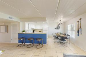 a kitchen with a blue counter and stools at Fiesta Sol Condominiums in South Padre Island +21 photos