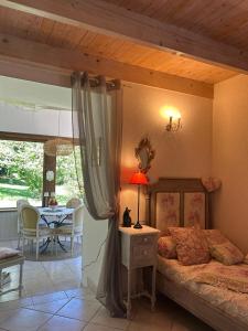 a bedroom with a bed and a table in a room at La Maison de Marie in Langonnet