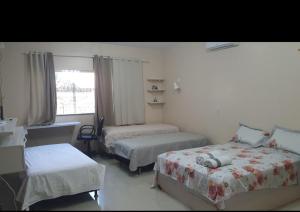 En eller flere senge i et værelse på Casa 5 quartos Aluguel Temporada Residencial Mirandinha