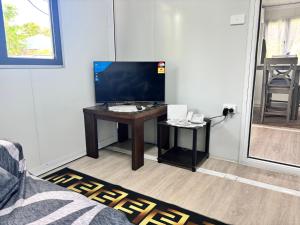 a living room with a desk with a television on it at Maui Guesthouse in Nuku‘alofa