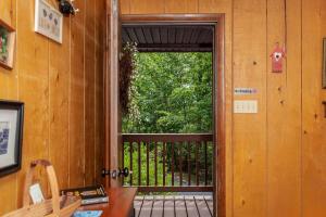 an open door to a balcony with a view of trees at Private w Screened Porch, Deck & Dog-Friendly! in Luray