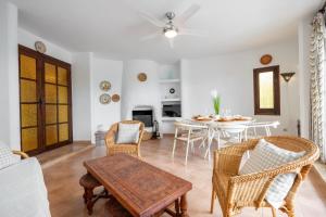 a living room with a table and chairs at Casa Saona En Riumar ( a 100m de la playa ) in Riumar +18 photos