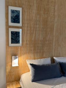 a bedroom with a bed with two pictures on the wall at Ferienwohnung FÜNF Hof Himmelgrün in Saal