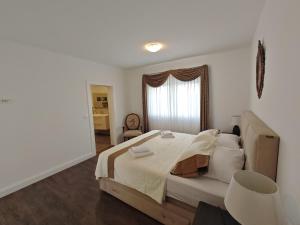 a bedroom with a large bed and a window at Vila Kathy - kuća za odmor in Seget Vranjica +34 photos