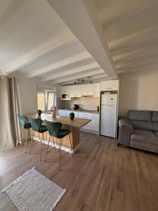 a kitchen and living room with a table and chairs at La Casa Del Buddha - Adults Only in Suances
