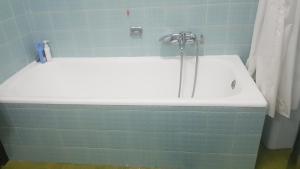 a bath tub with a faucet in a bathroom at La terrazza Iseana in Predore +24 photos