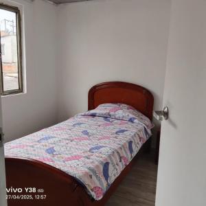 a bedroom with a bed with a quilt on it at Apartamento completo Santa Rosa de Cabal in Santa Rosa de Cabal