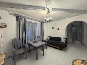 a living room with a couch and a table at Гостинний двір in Yaremche