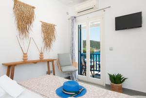 a living room with a door leading to a balcony at Studio Anna in Vathi