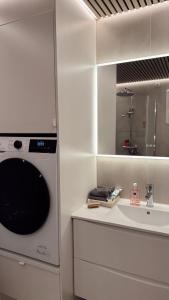 a bathroom with a sink and a mirror at Panoramic views in Henningsvær in Henningsvær +36 photos