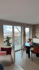 a living room with a couch and a table at Panoramic views in Henningsvær in Henningsvær