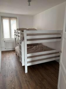 two bunk beds in a room with wooden floors at Chez Marceau in Munster