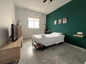 a bedroom with a bed and a flat screen tv at Mirador de aguadulce in Aguadulce