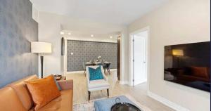 a living room with a couch and a table at Casa Hotel Contemporary 2BR Suite w Patio & BBQ in Toronto