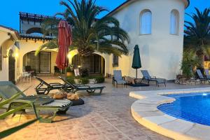 a courtyard with a swimming pool and a house at Villa Lobos in Lliber