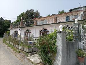a house with a fence in front of it at Villa vista mare in Varazze