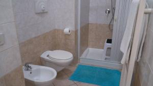 a bathroom with a toilet and a sink and a shower at Barbahouse in Monte SantʼAngelo +7 photos