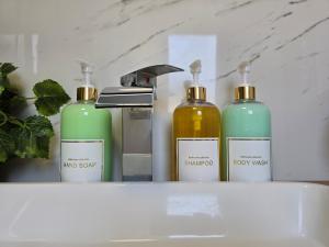 a group of four bottles sitting on top of a sink at HomeholidaySanremo - Classic in Sanremo +31 photos