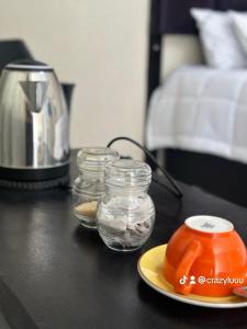 a table with three jars of water and a blender at Rose's Lodge in Ga-Selala