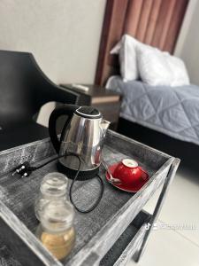 a tea kettle on a tray on a table at Rose's Lodge in Ga-Selala