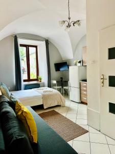 a bedroom with a bed and a couch in a room at BD KRAKOW Apart Hotel in Kraków