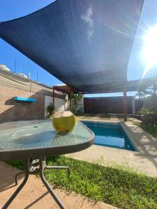 a blue canopy over a pool with a table at Casa Villa Noa in Puerto Escondido