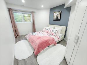 a small bedroom with a bed and a window at Gorgeous Two Bedroom Suite in a Quiet, Picturesque Neighborhood! in West Vancouver