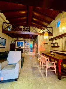 a living room with a couch and chairs and a table at Harmony Home in Pyrgos +44 photos