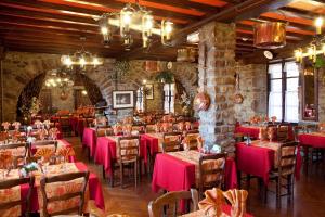 a restaurant with pink tables and chairs in a building at La Vieille Auberge in Le Mont Saint Michel