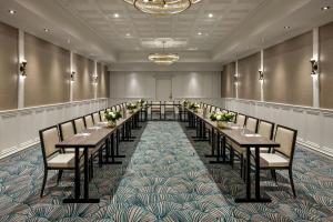 a row of tables in a room with chairs at The Talbott, Autograph Collection in Chicago