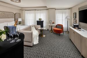 a hotel room with a bed and a couch at The Talbott, Autograph Collection in Chicago