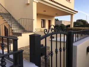 a fence in front of a house with stairs at Residence Olbia in Olbia