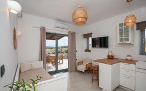 a kitchen and living room with a balcony at Livadi Resort in Adamas +50 photos