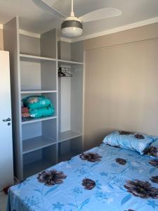 a bedroom with a blue bed with flowers on it at Ap Confortável e Acolhedor perto da Orla Atalaia in Aracaju +9 photos