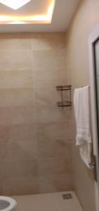 a bathroom with a shower with a toilet and a sink at Serenity Cottage in Islamabad