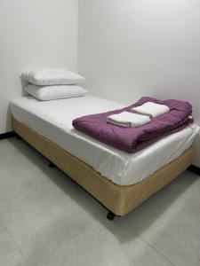 ein Bett mit zwei Kissen darauf in der Unterkunft KL City Nue Suites Entire Condo 2R2B 3 plus 1 guests in Kuala Lumpur + 78 Fotos