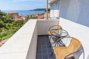 a balcony with two chairs and a table at Apartments Harmonija in Budva