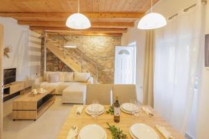 a living room with a table and a couch at Pavlos & Sofia Villa Vigla - Heated Private Pool in Ágios Matthaíos