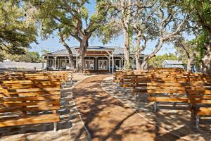 a group of wooden benches in front of a building at The Claire Hotel in Canyon Lake +14 photos