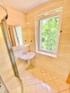 a bathroom with a sink and a window at XXXXx in Świnoujście